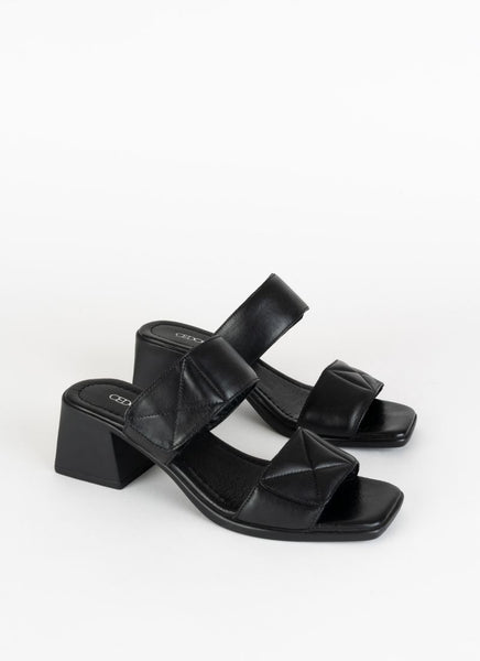 Ein Paar eleganter Sandalen aus Leder in schwarz mit Karree Leisten, einem ca. 6 cm hohen Blockabsatz und zwei gepolsterten Riemen im Quilted-Look. Der obere Riemen hat einen Klettverschluss.