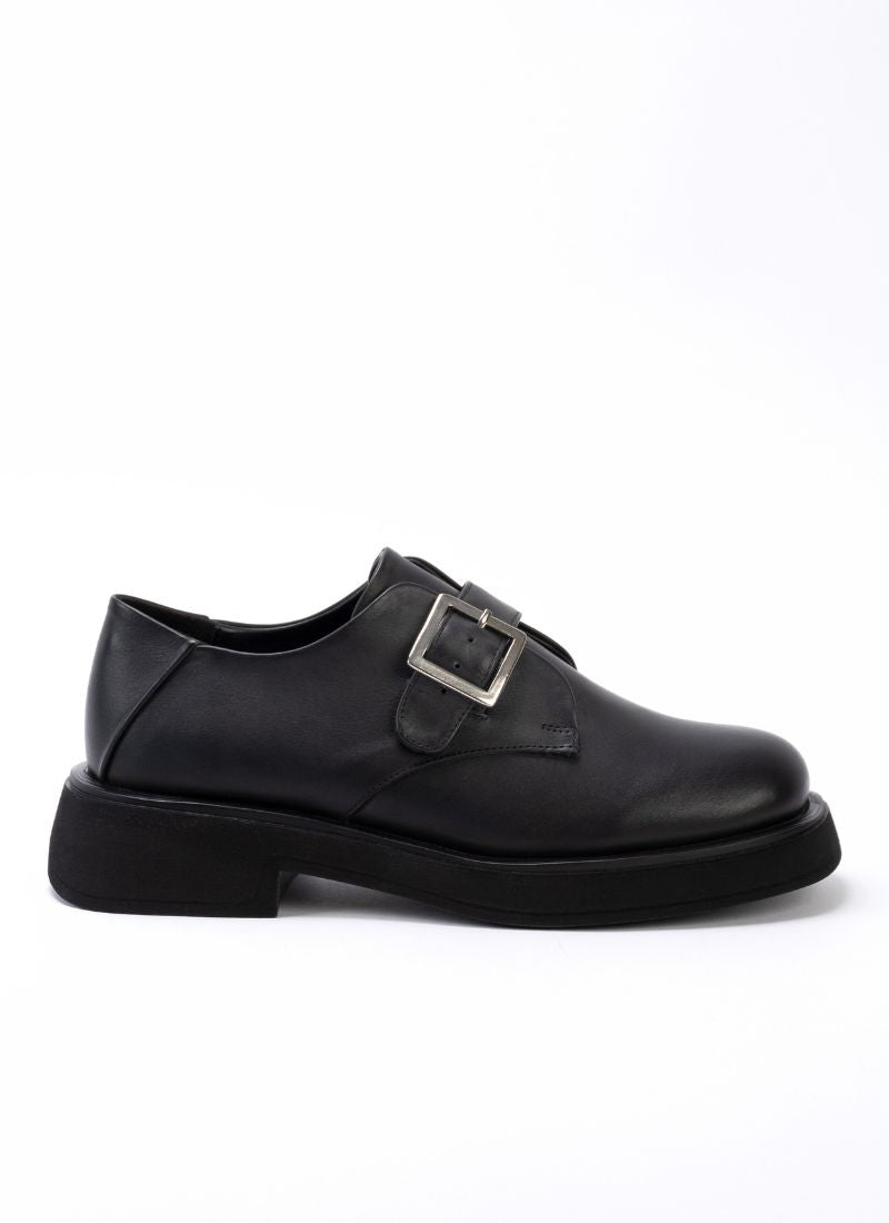 Klassisch-cooler Unisex-Schuhs aus zeitlosem, schwarzem Leder mit Riemen und Schnalle, die Schuhspitze ist eine Mischung aus Karree und rund.